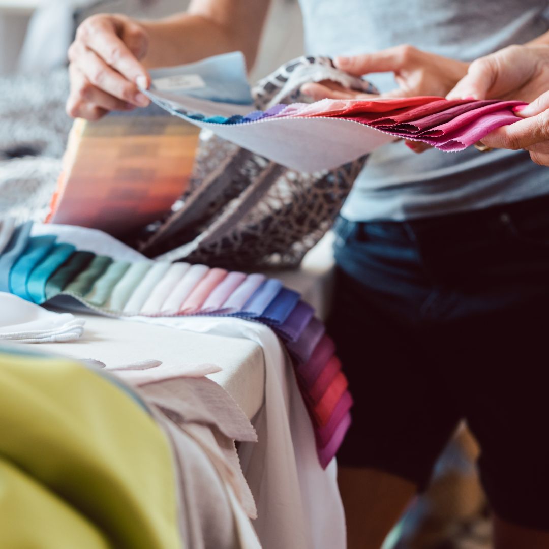 Person looking through fabric swatches. 